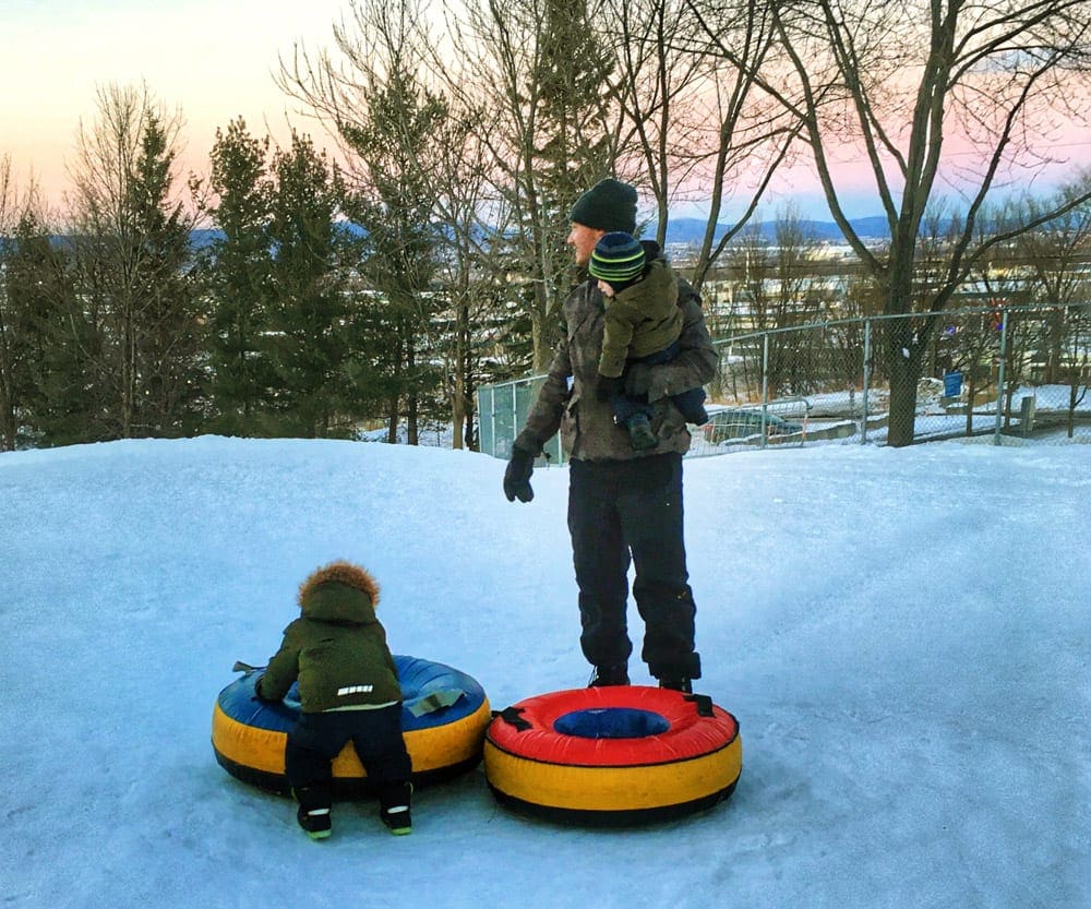 kid and dad with snow tube
