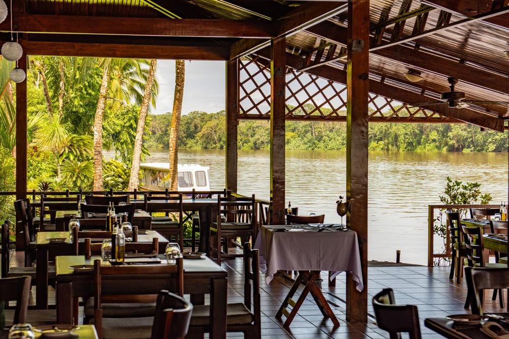 The dining area, nestled along the water, at Tortuga Lodge & Gardens.
