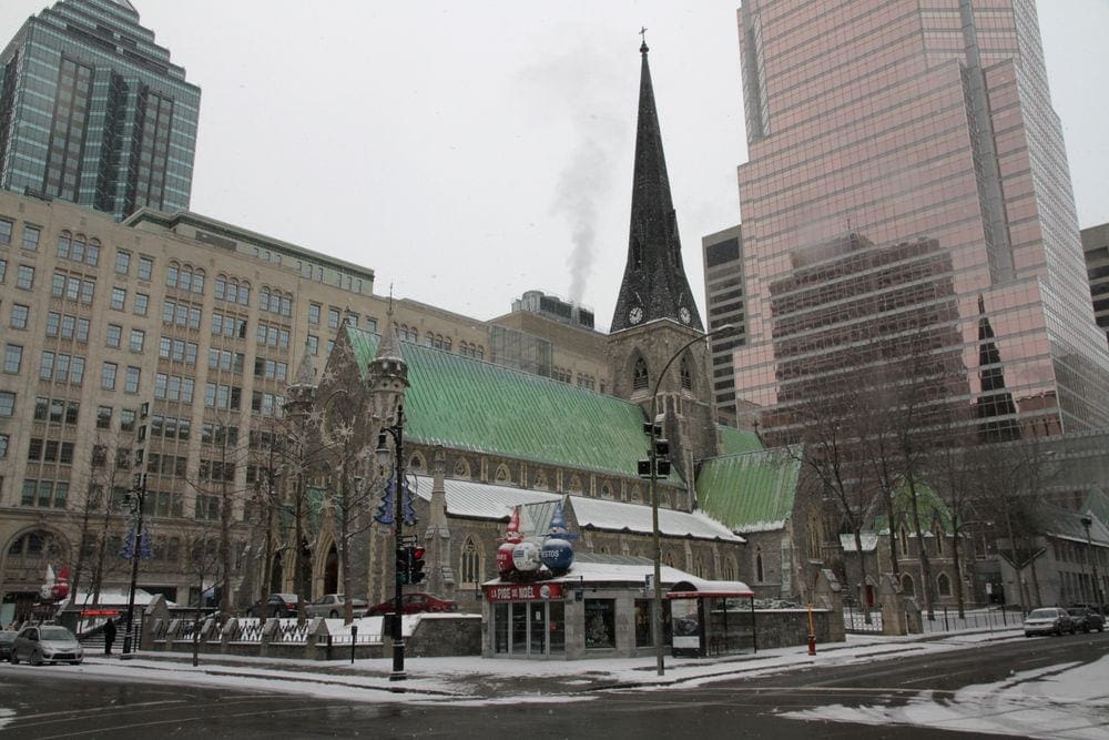 A view of a large church in Montreal, with light snowcover.