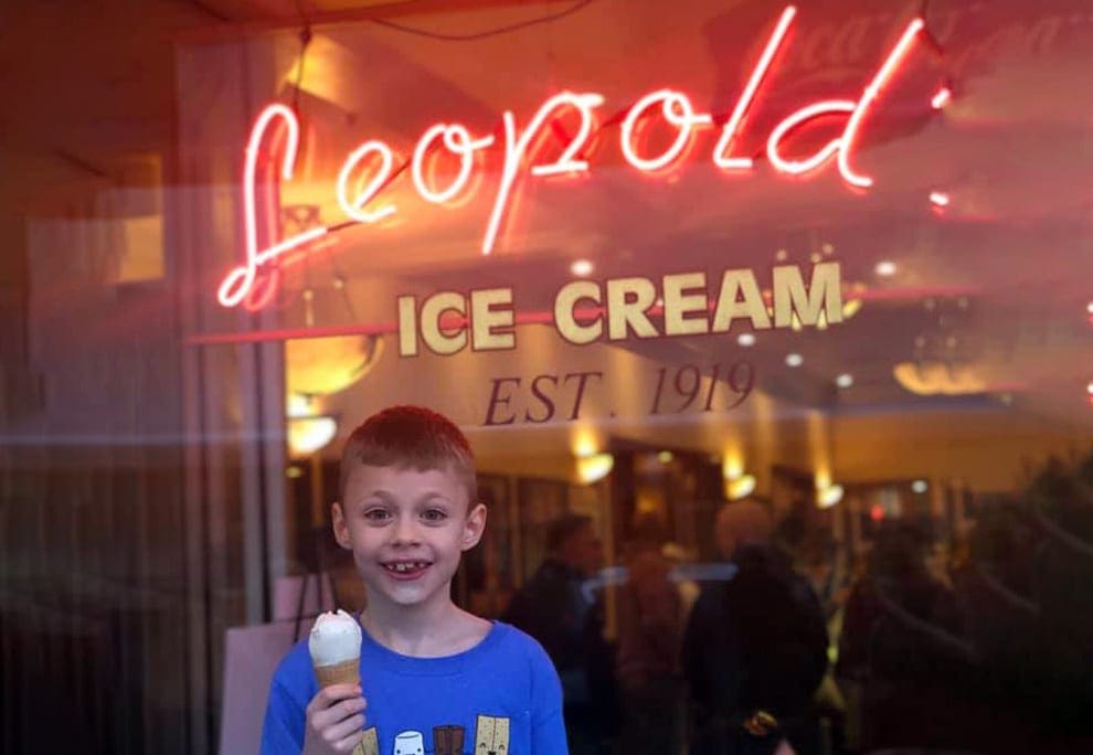 A young boy grins with his ice cream cone outside the inconic Leopold’s Ice Cream, one of the best things to do in Savannah with kids.