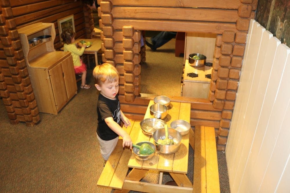 A young boy points at play dishes inside the Children's Museum in Chicago.