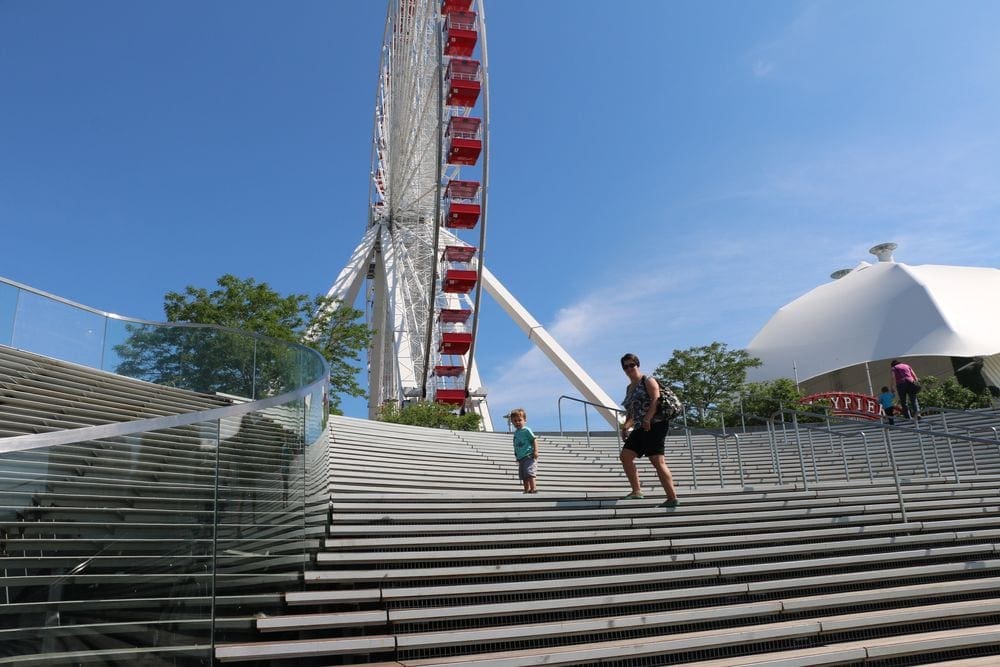 A young boy and his mom climb the stairs toward the ferris wheel inside Navy Pier in Chicago.