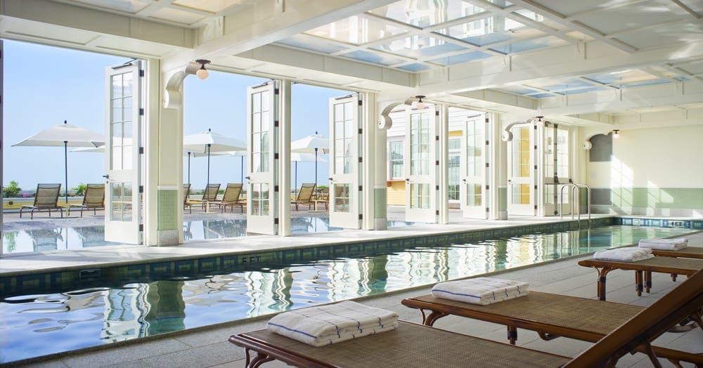 The indoor pool with open air doors at the Ocean House on a sunny day.