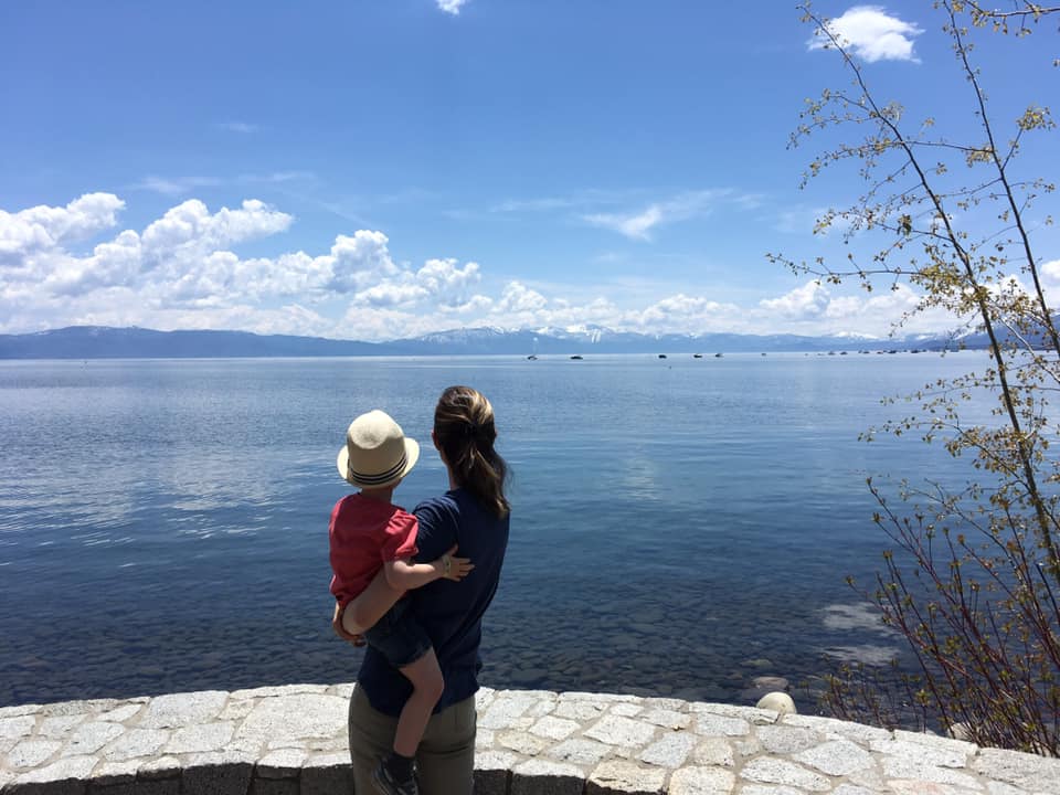 Mother and son from the back looking at Lake Tahoe, one of the best Summer Vacation Ideas in the U.S. for Families.