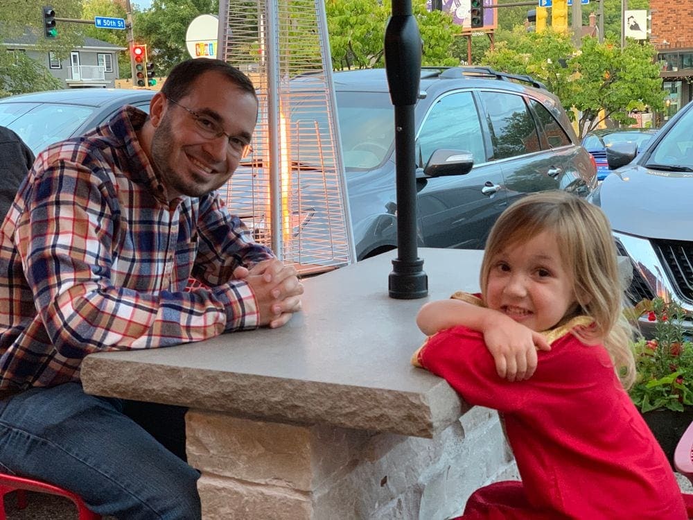 A dad and his daughter enjoy a patio dinner at Broders' Pasta bar in Minneapolis.