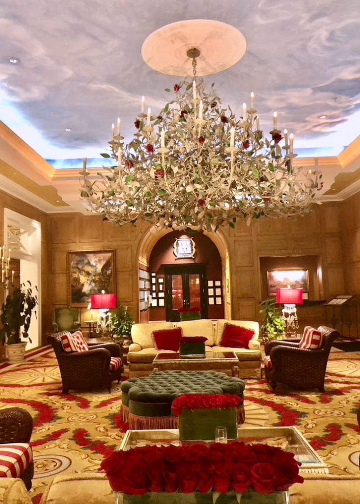The grand entrance of the Broadmoor Hotel lobby, including an impressive chandelier and plush chairs.
