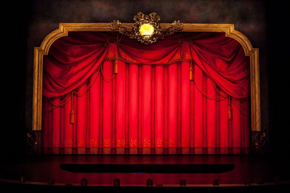 A closed red curtain on stage at the Children's Theatre Company in Minneapolis.