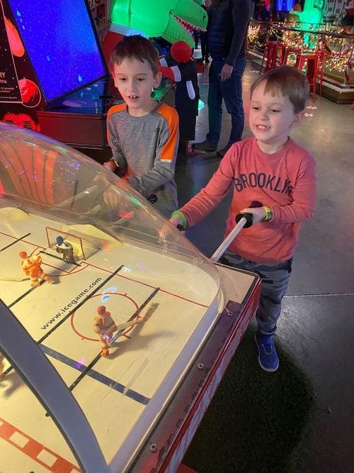 Two kids play an arcade game at Can Can Wonderland, one of the best things to do in Minneapolis with kids.