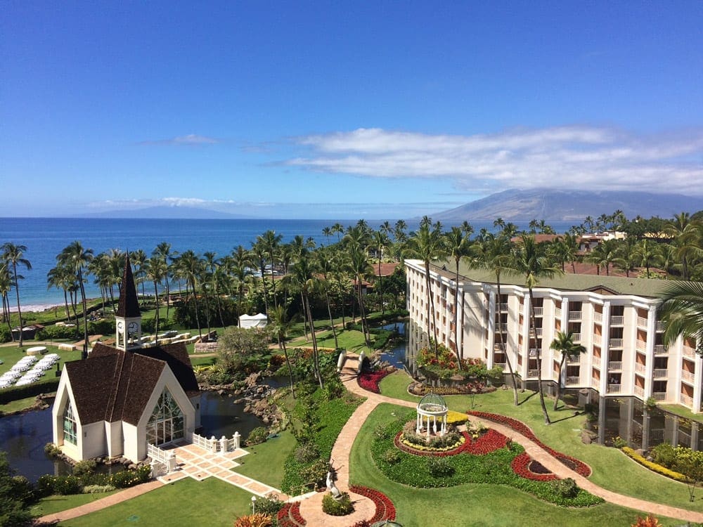 An aerial view of Grand Wailea Maui, A Waldorf Astoria Resort, one of the best family hotels in Maui, featuring lush grounds and pristine buildings.