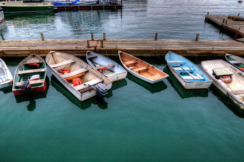 Several colorful boats rest at a dock in Bar Harbor, Maine.
