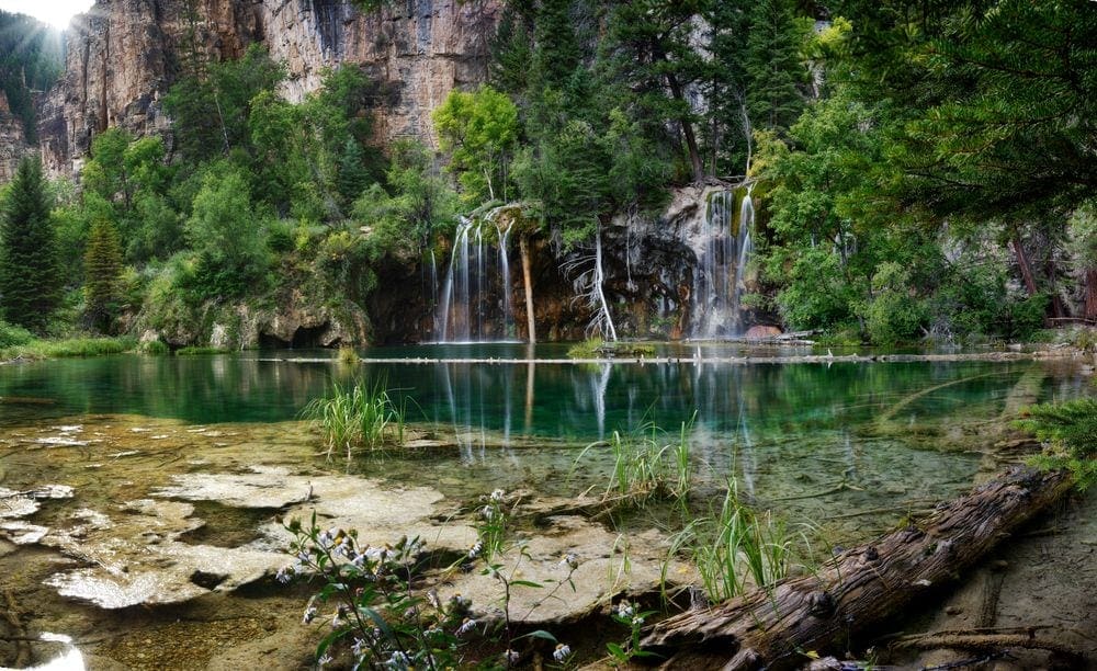 A view of the stunning warterfalls and clear-glass lake at Hanging Lake, one of the best things to do in Colorado with kids.