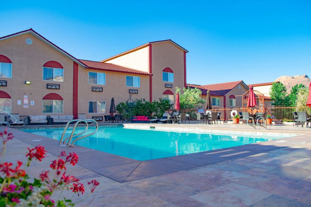 The outdoor pool, with hotel buildings behind it, at the Aarchway Inn, one of the options for hotels in Moab for families.