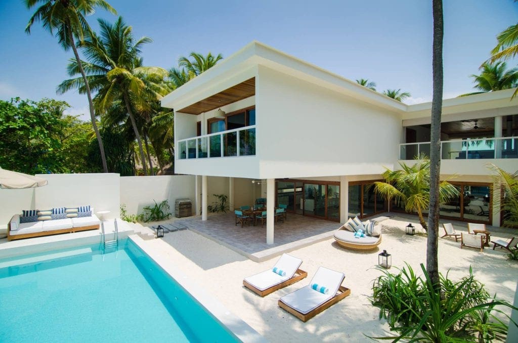 One of the residences at the Amilla Maldives Resort and Residences, featuring a private pool and patio area.
