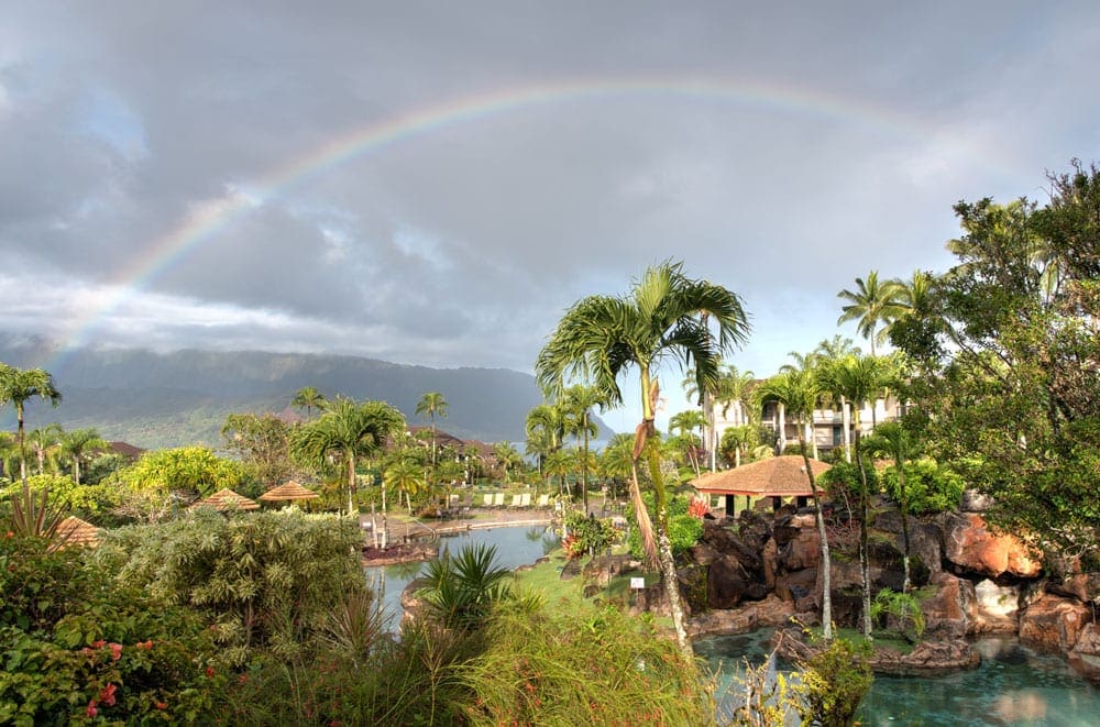 A view of the Hanalei Bay Resort, with a rainbow overhead.