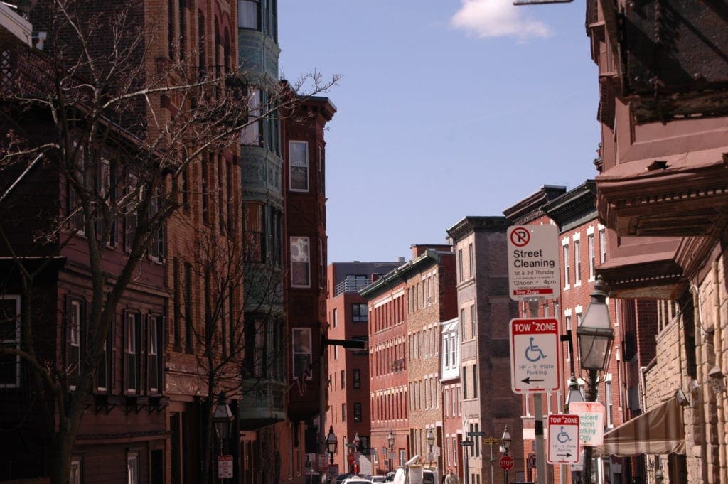 A view of Boston's North End, featuring a series of buildings and street signs.