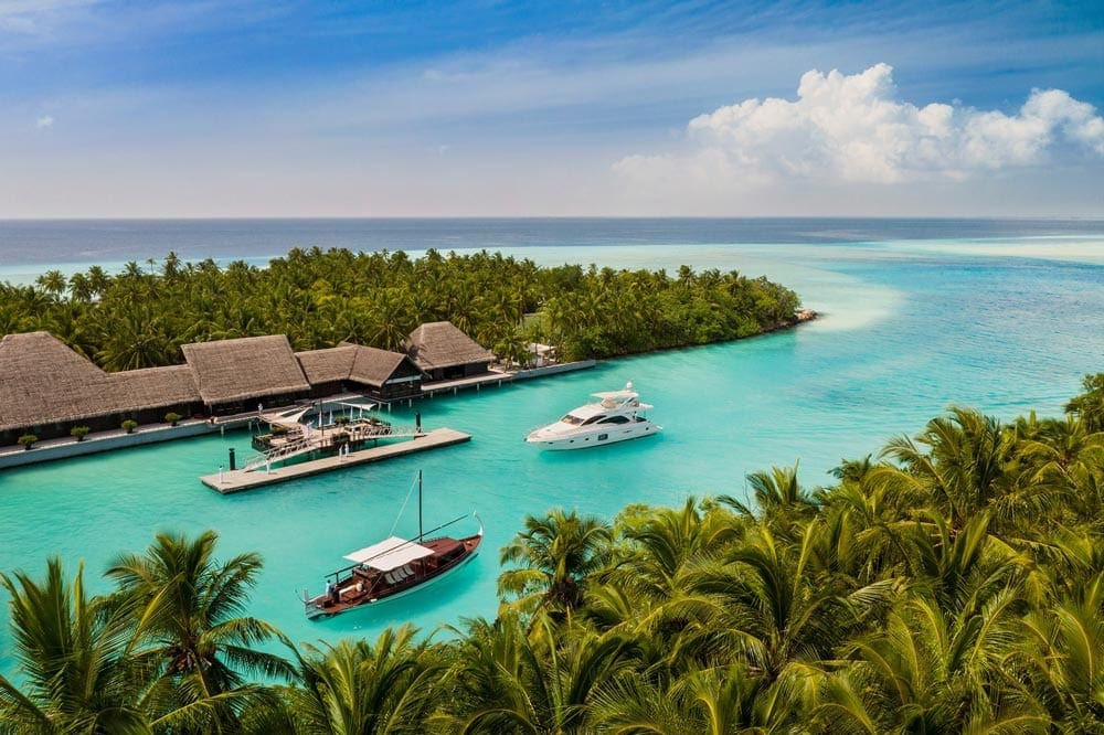 Several boats go in an out of the small inlet marina at the One & Only Reethi Rah, one of the best family hotels in the Maldives.