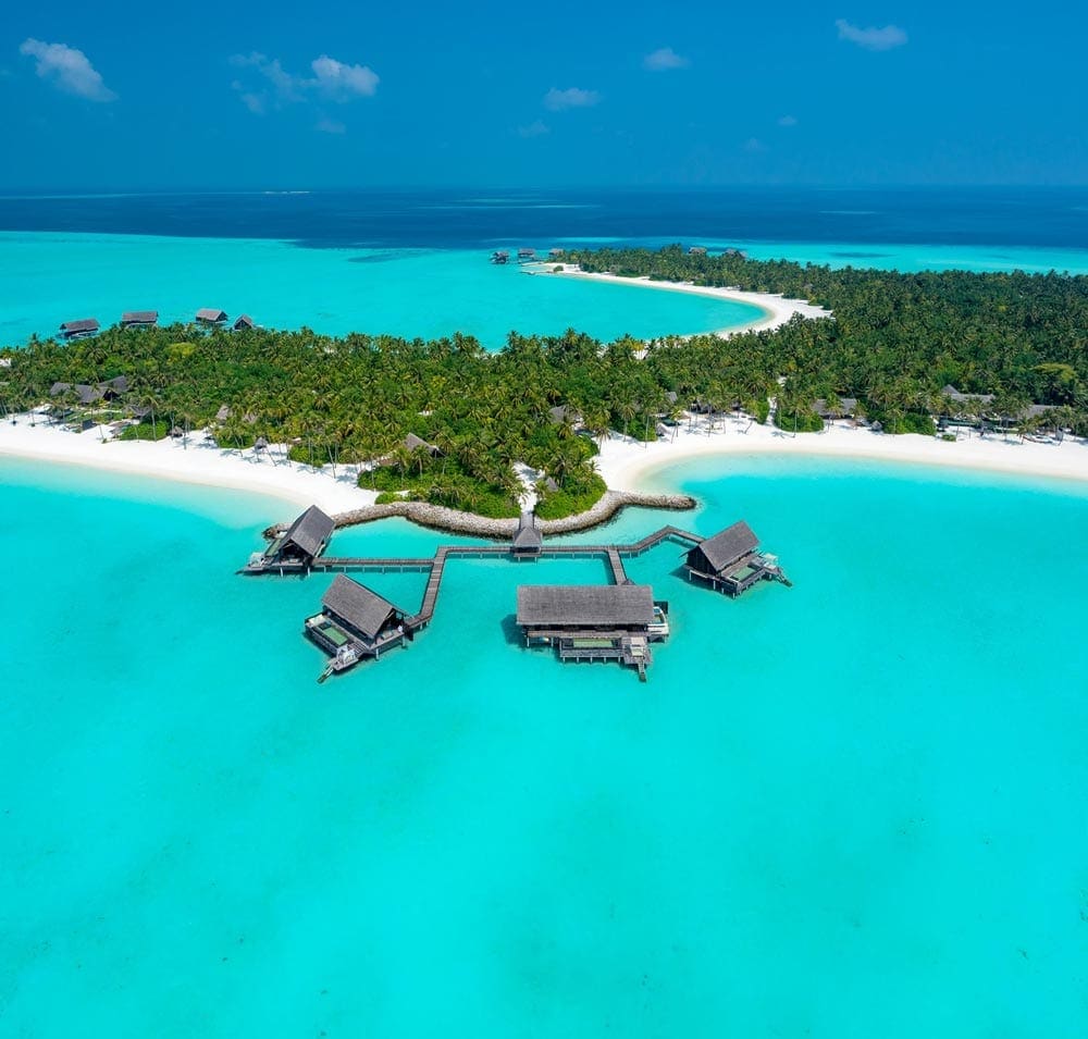 An aerial view of the over-water bungalows at the One & Only Reethi Rah, one of the best family hotels in the Maldives.