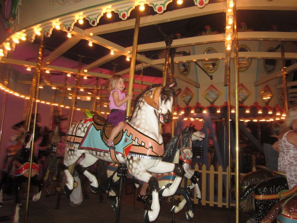 A young girl enjoys a carousel ride at the Indianapolis Children's Museum.