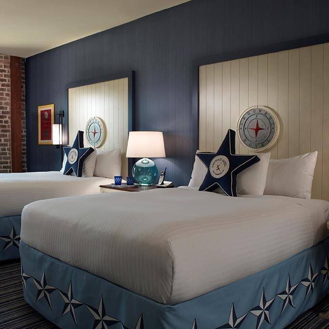 Inside one of the nautical-themed rooms at the Argonaut Hotel - a Noble House Hotel, featuring star pillows on the beds.