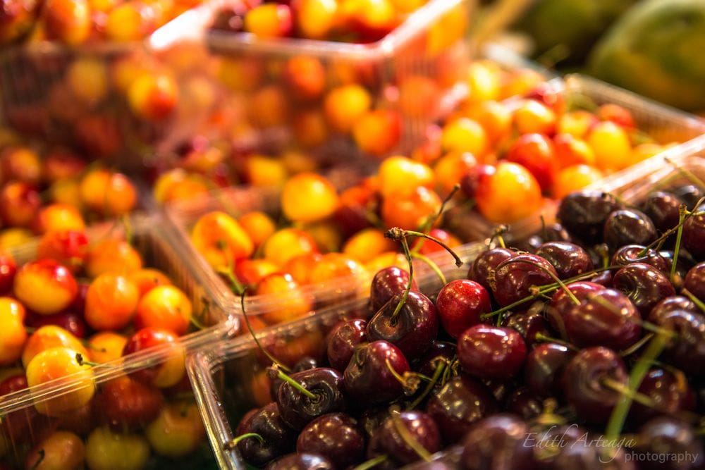 Bing cherries and deep red cheeries sit in crates at the Pike Place Market.