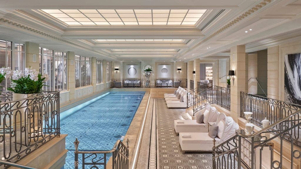 The luxurious indoor pool and poolside loungers at the Four Seasons Hotel George V, Paris.