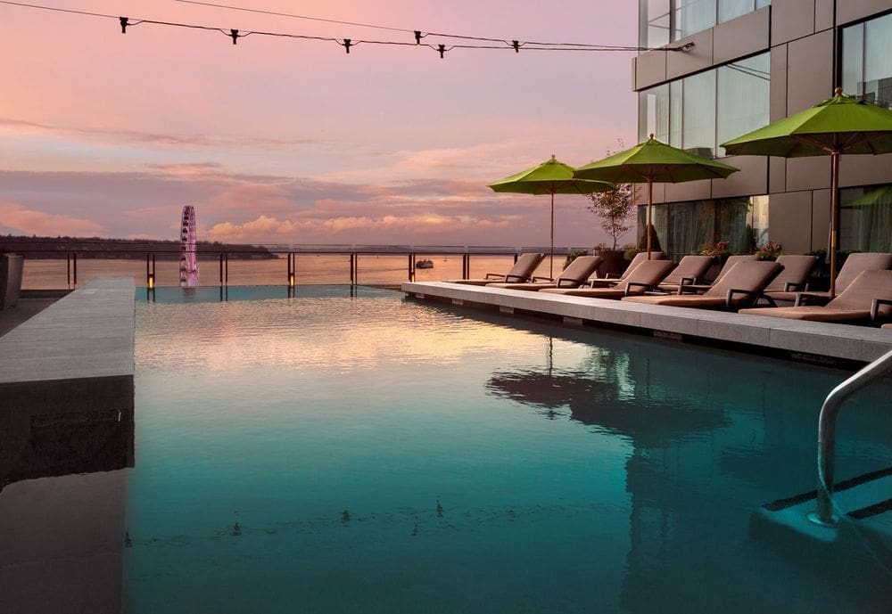 The rooftop pool overlooking Seattle at sunset at the Four Seasons Hotel Seattle.