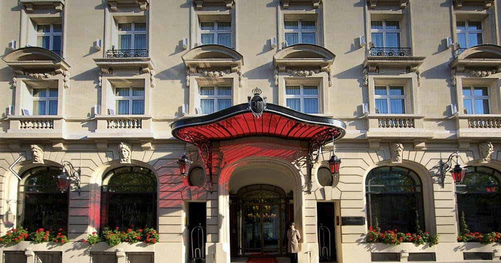 The entrance to the Hotel Le Royal Monceau – Raffles Paris, with its red awning front and center.