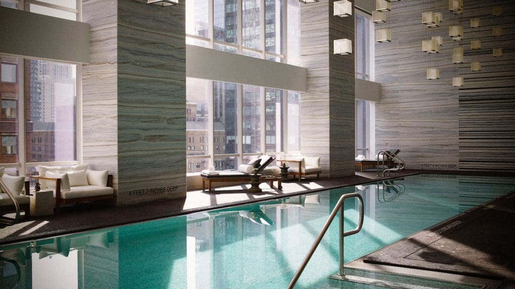 The swanky indoor pool at the Park Hyatt New York, with plush nearby poolside loungers.