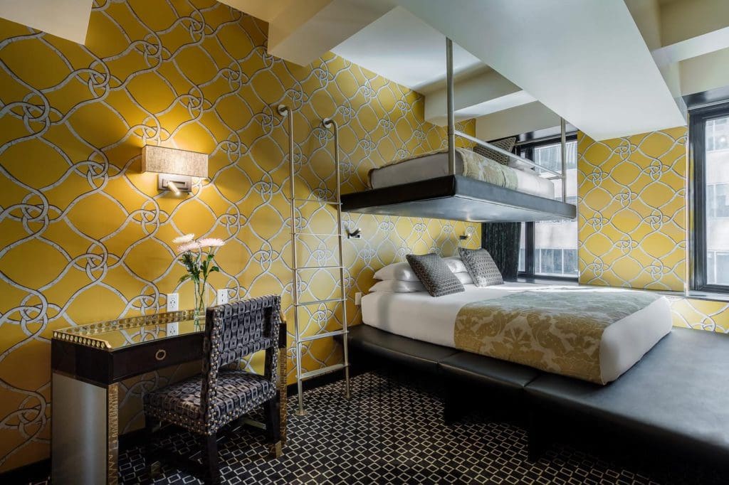 Inside a yellow-colored bedroom at the Room Mate Grace Hotel.
