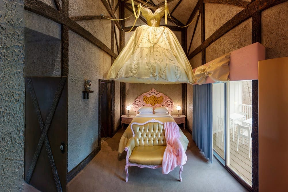 Inside the princess castle room at the The Roxbury, featuring a large dress and lush bedroom furniture.