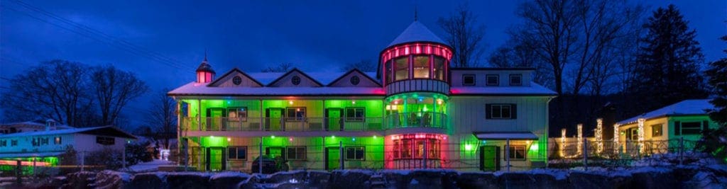 The Roxbury Motel lit up in an array of colorful lights, one of the best themed hotels in the United States for families.