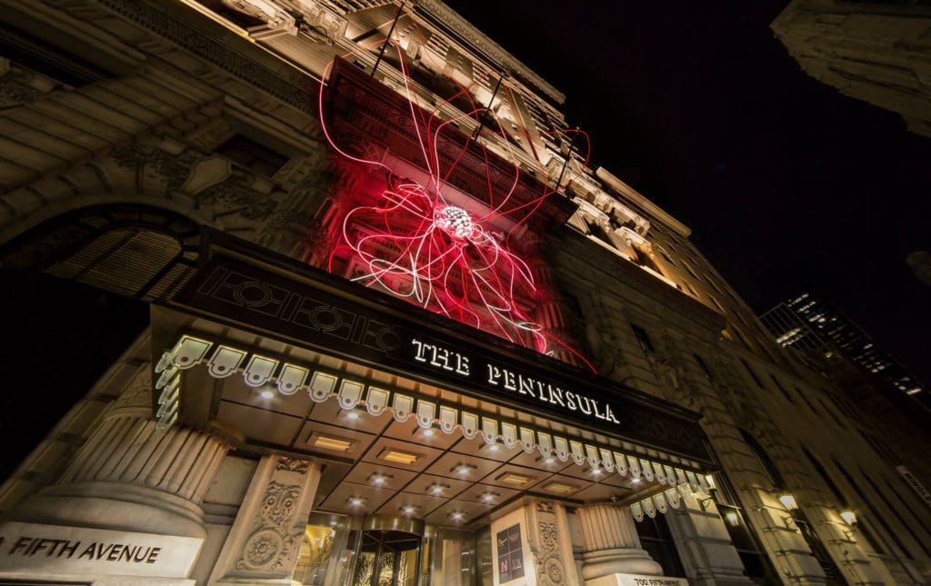 The electric-red and historic entrance to the The Peninsula New York.
