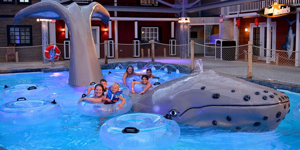 A close up of a large splash whale, with several kids playing on it at Cape Codder Water Park at Cape Codder Family Resort and Spa.