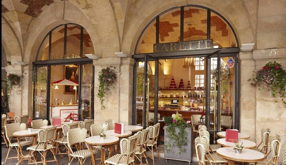 A charming outdoor seating area awaits guests for Carette, one of the best dessert destinations in Paris for families.