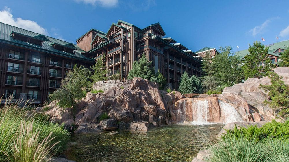 The exterior of the Disney Wilderness Lodge, across from its on-site pond, one of the best themed hotels in the United States for families.