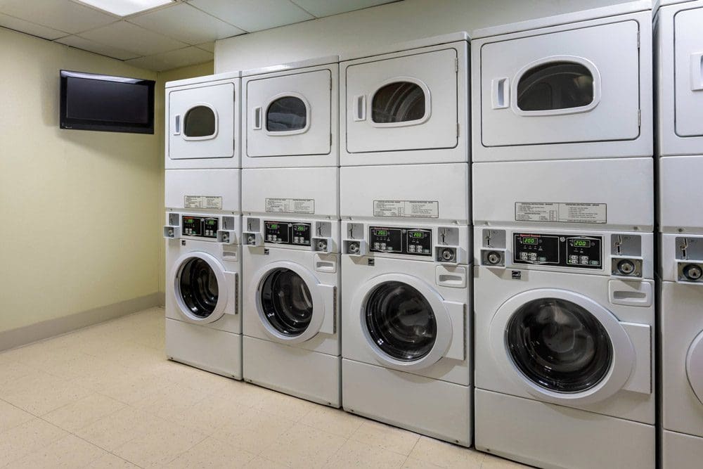 Inside the laundry room at the Residence Inn by Marriott Chicago Downtown / River North, featuring a clean facility and several machines.