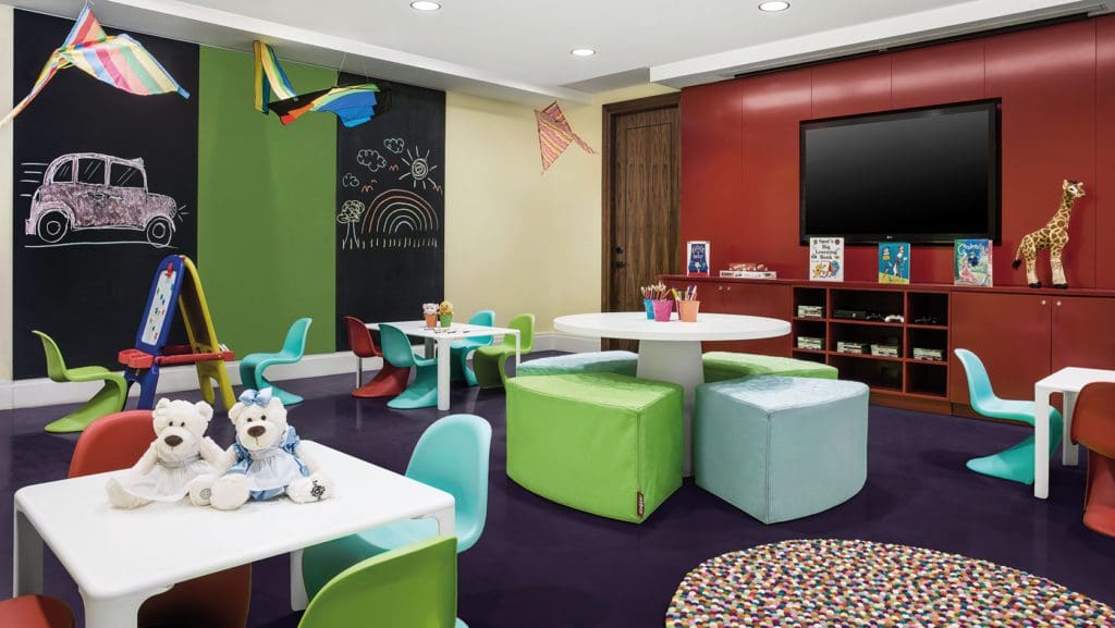 Indoor kids play room at the Langham Chicago, one of the best family hotels in Chicago. It's filled with toys, educational books, and tables for them to play.