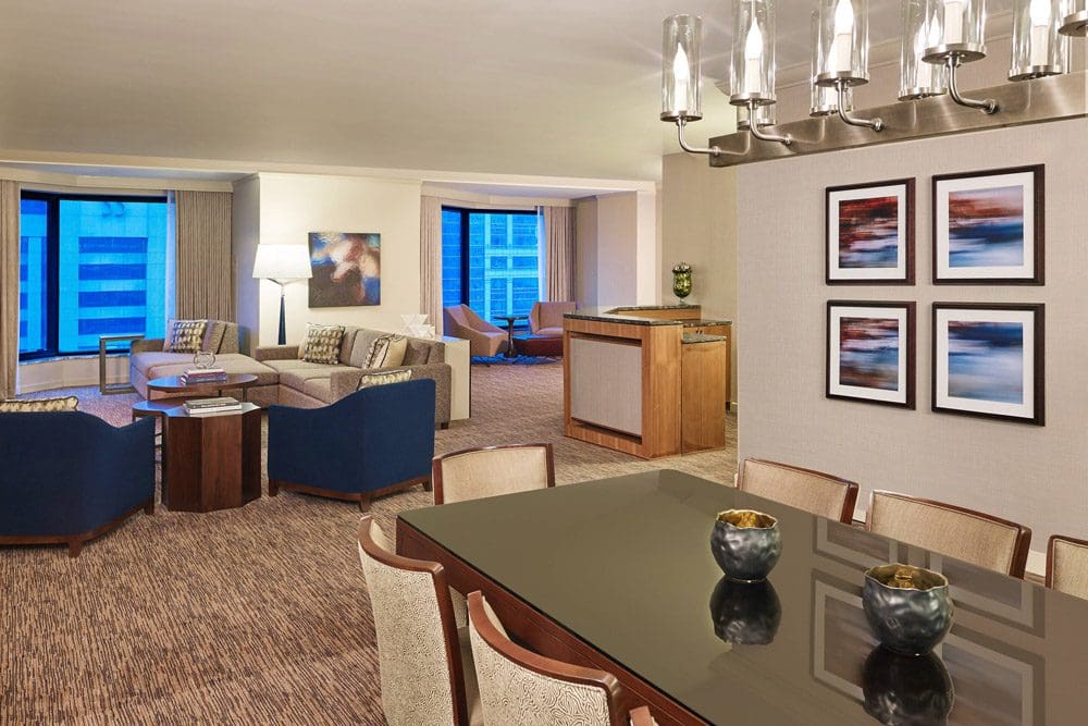 Inside a suite at the The Westin Chicago River North, featuring a large table and seating area.