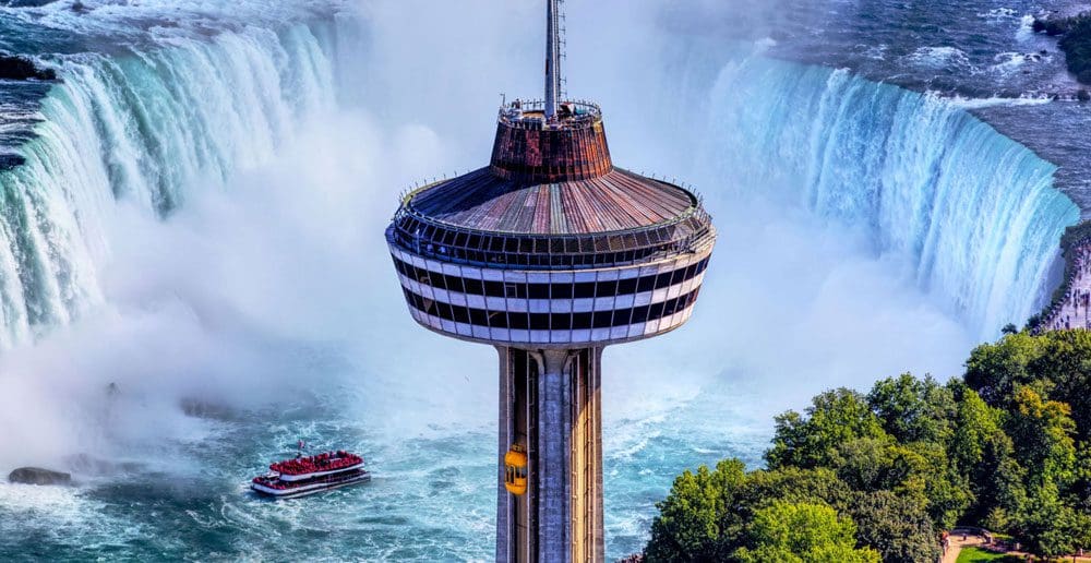 A view of the Skylon Tower, with an expansive view of Niagara Falls behind it.