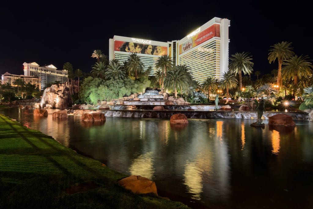 The lit-up exterior of The Mirage, across the on-site pond.