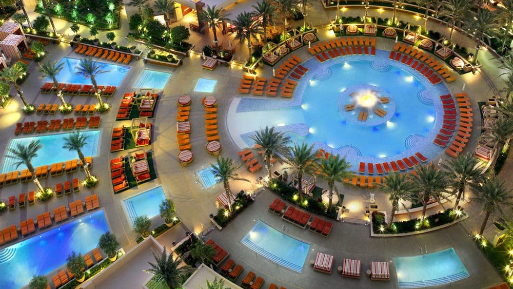 An aerial view of the large pool and surrounding smaller pools and pool decks at the Red Rock Casino Resort and Spa, one of the best hotels in Las Vegas for families.