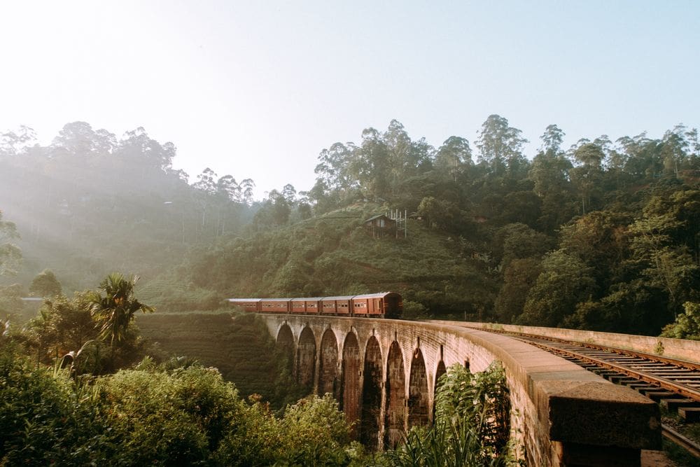 A train rounds a corner on an elevated track in Sri Lanka, one of the best weekend getaways from Dubai for families.