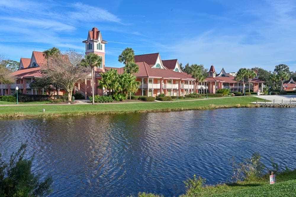 A view of the Caribbean Beach Resort across the water, one of the best themed hotels in the United States for families.