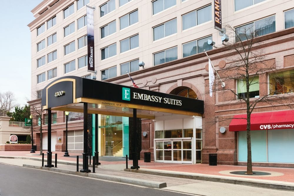 The entrance to the Embassy Suites By Hilton Washington DC Chevy Chase Pavillion, featuring a covered walkway.