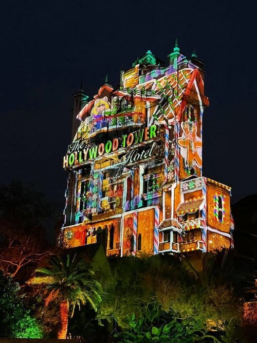 The Tower of Terror lit up like a gingerbread house, including several cameo appearances from muppets like Ms. Piggy.