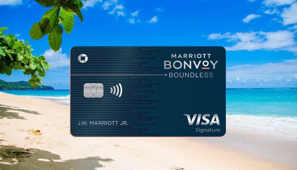 A close up of the Visa Marriott Bonvoy Boundless credit card, nestled on a background of a pristine beach and stunning ocean view.