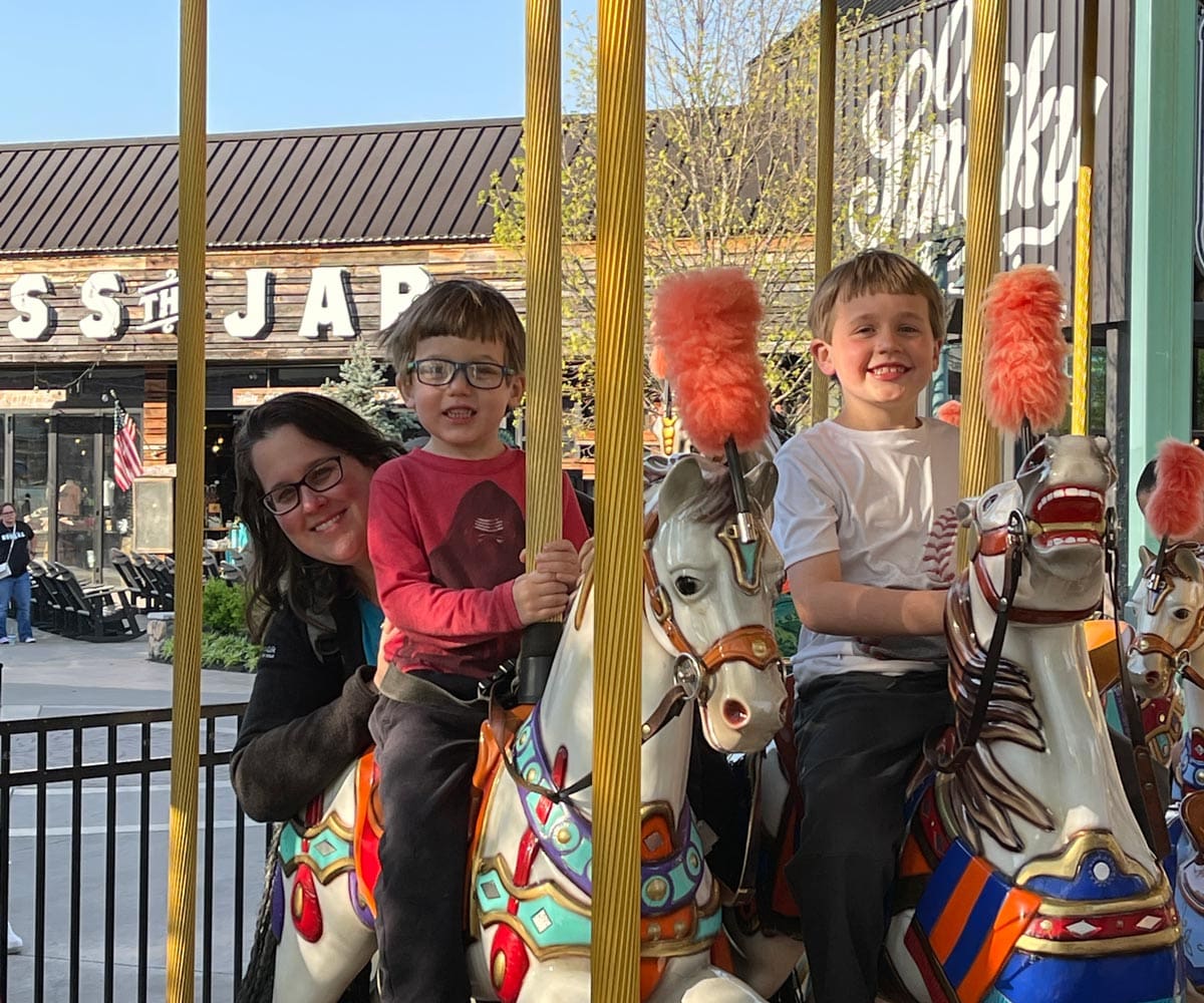 A mom and her two sons enjoy a carousel near Gatlinburg.