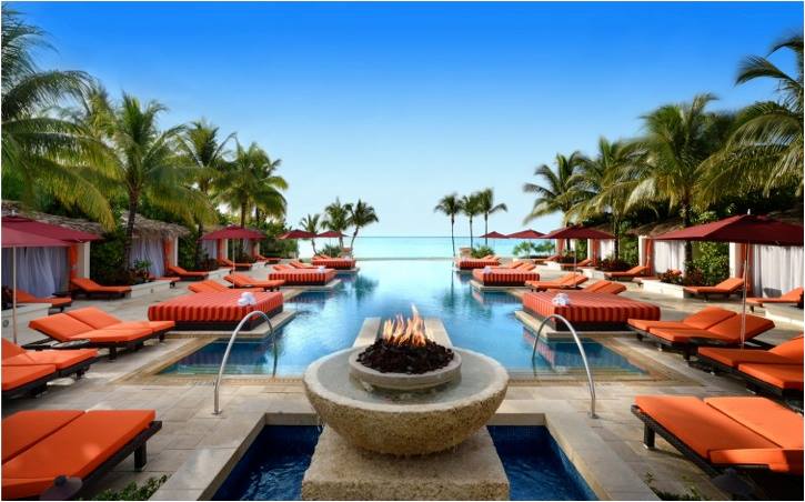 The pool and surrounding orange pool loungers at the Albany, The Bahamas.