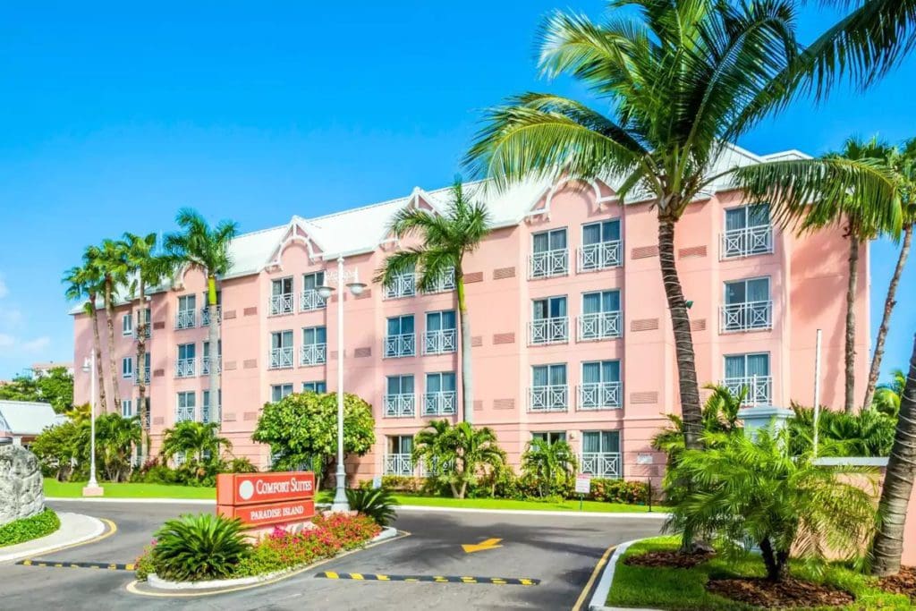 The exterior entrance and sign to the pink-hued Comfort Suites Paradise Island.