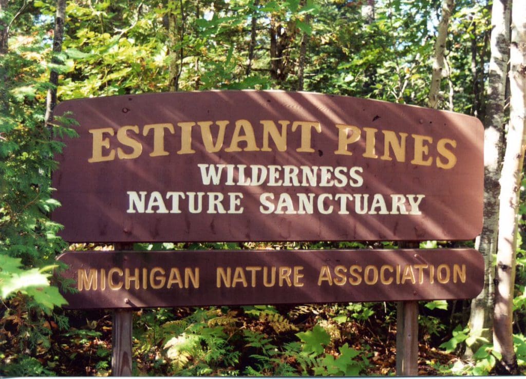 A sign reading "Estivant Pines Wilderness Nature Sanctuary".